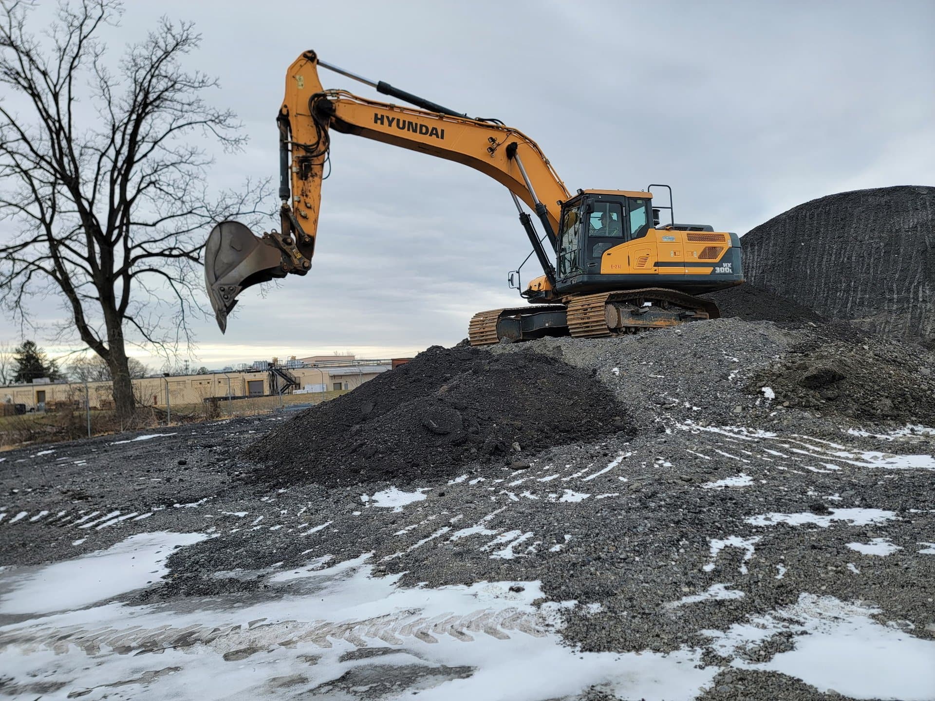 EW Wise Hyundai excavator working a material stockpile