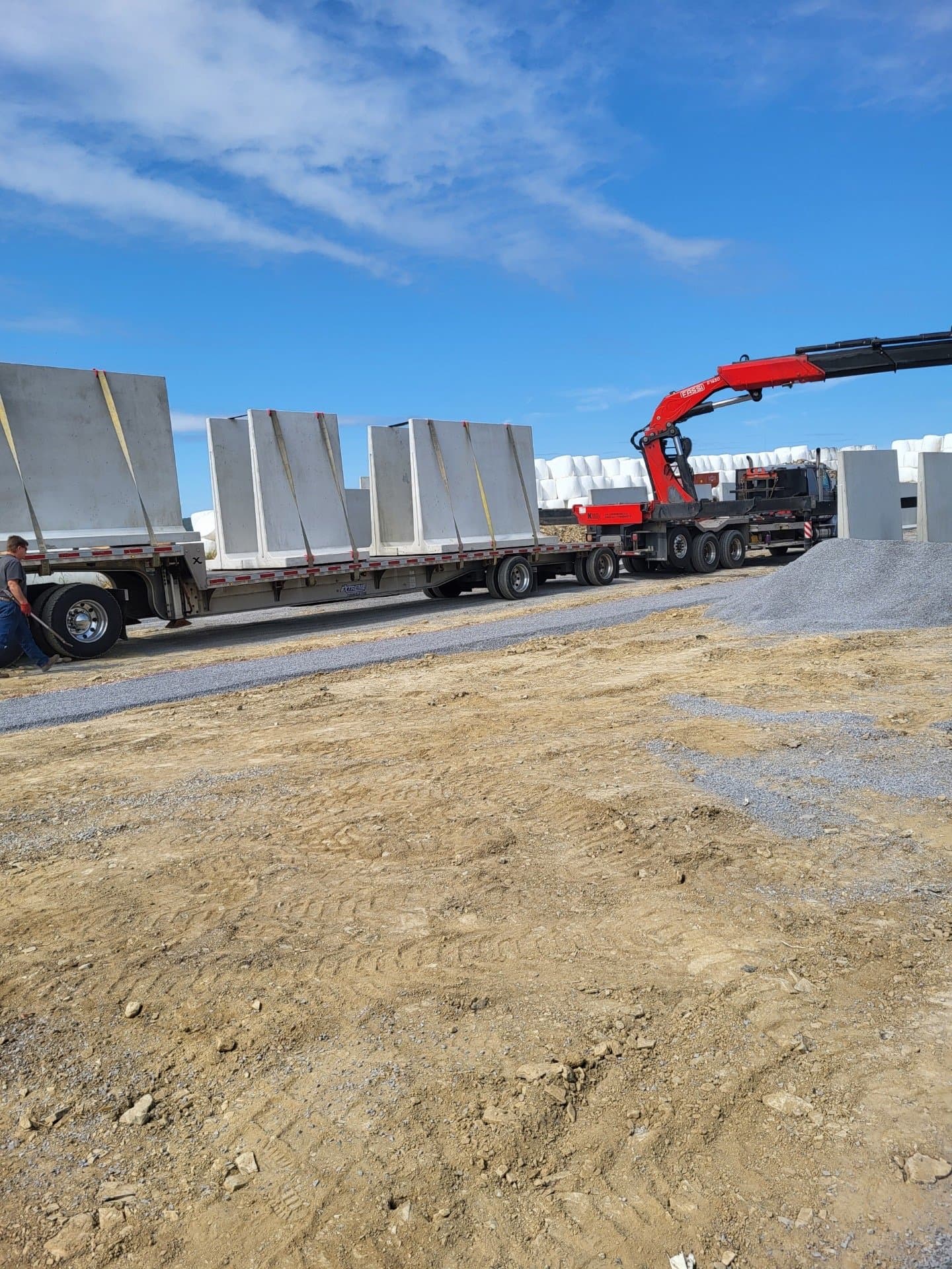 Crew running a precast retaining wall up the driveway approach