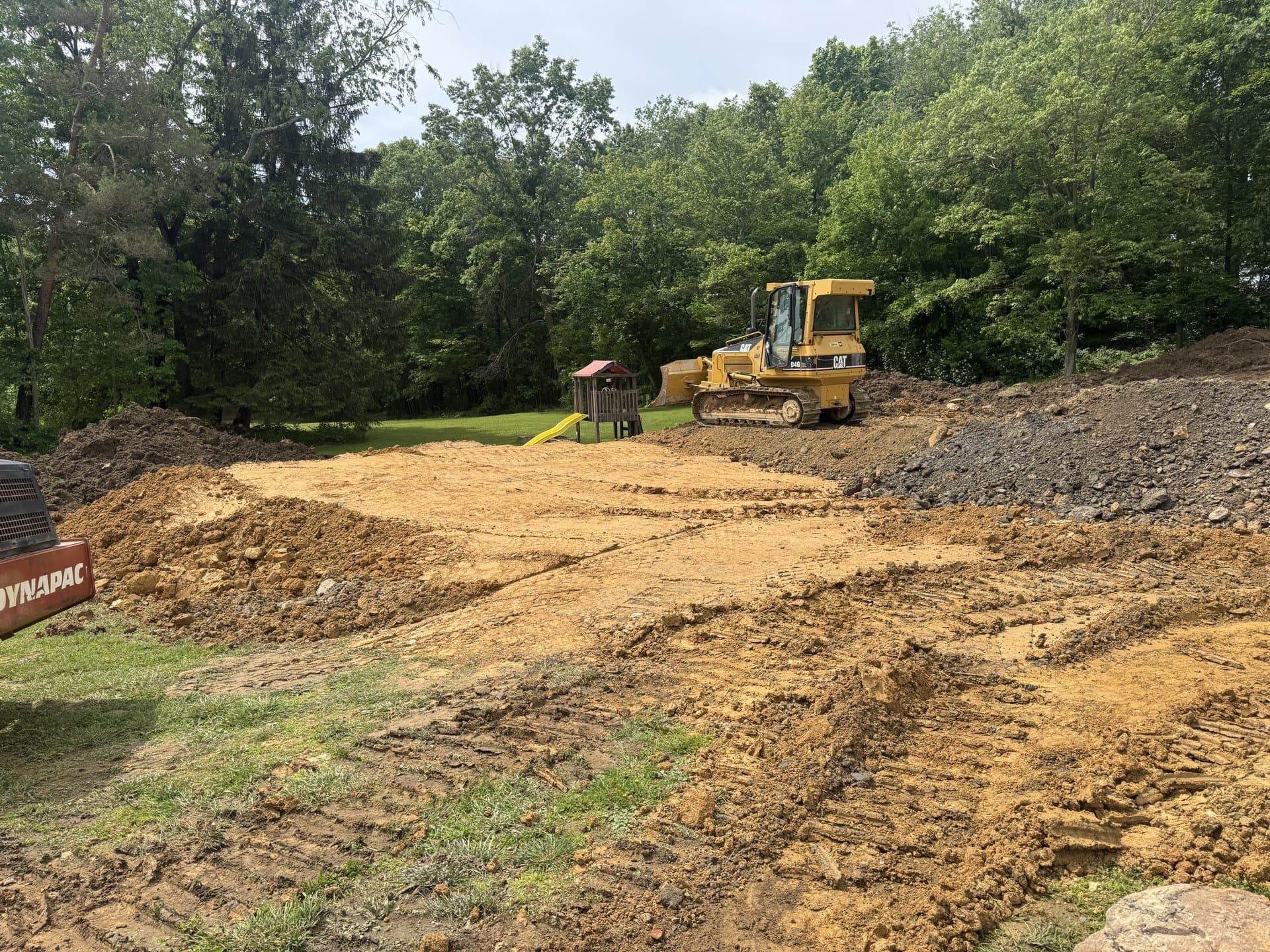 Excavator working the final pass on a rough grade