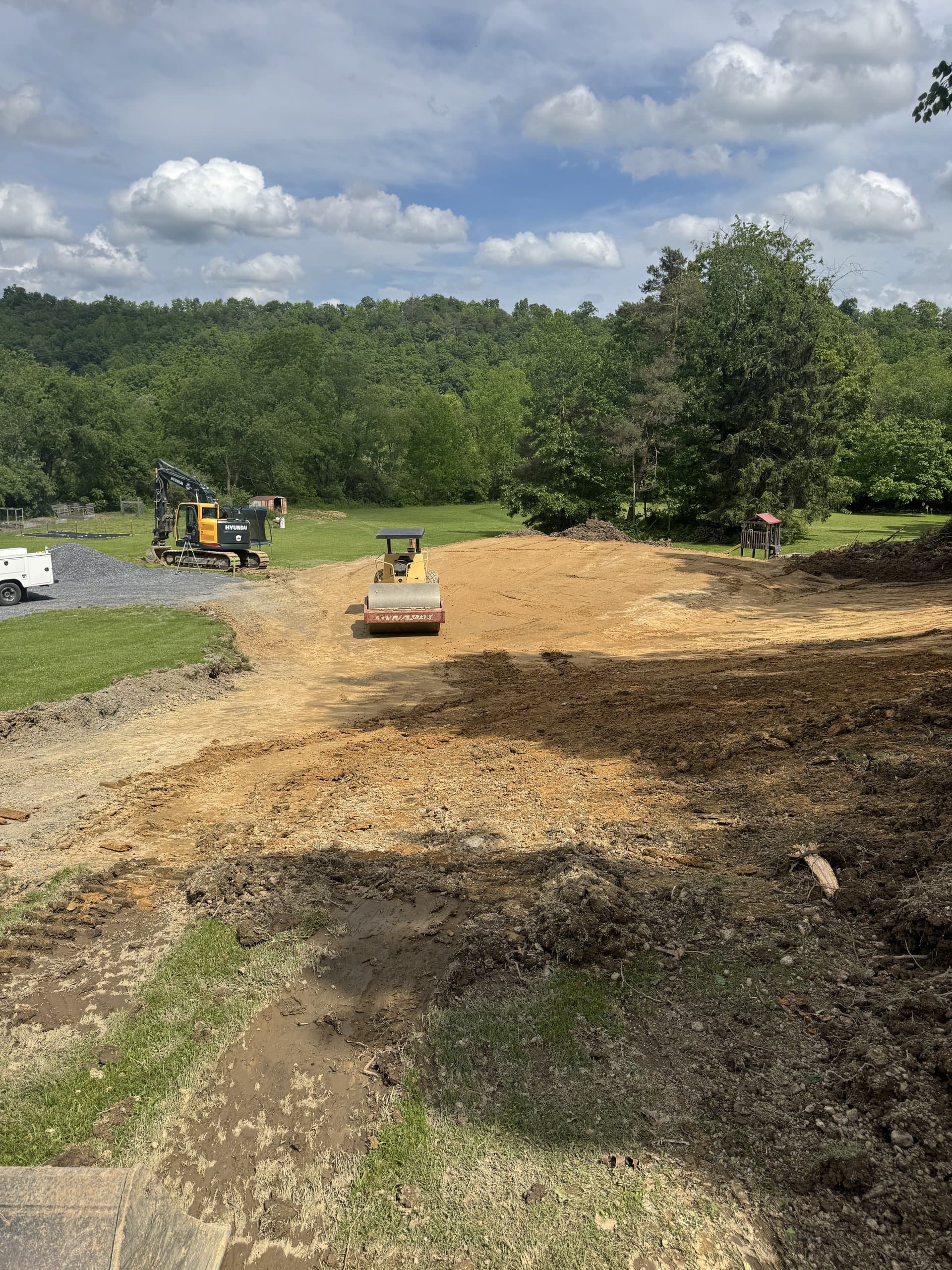 Excavator and dump truck working a site cut together