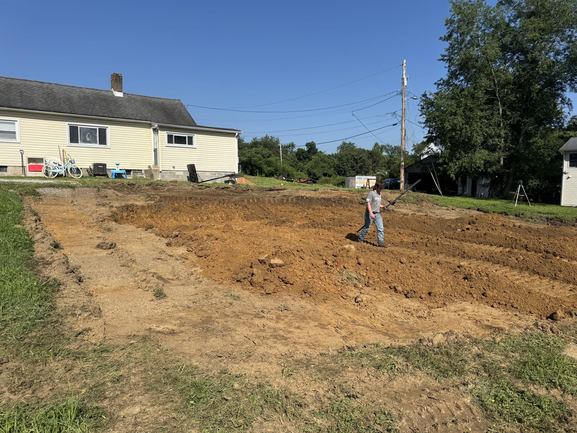 Fresh-graded yard next to a Bedford homeowner's house