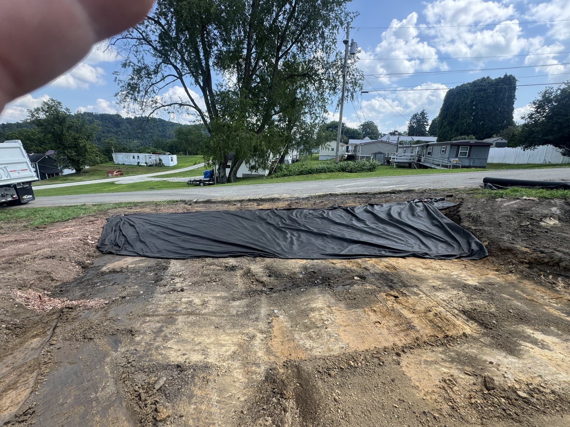 Residential cut with silt fence installed, graded and ready for seed