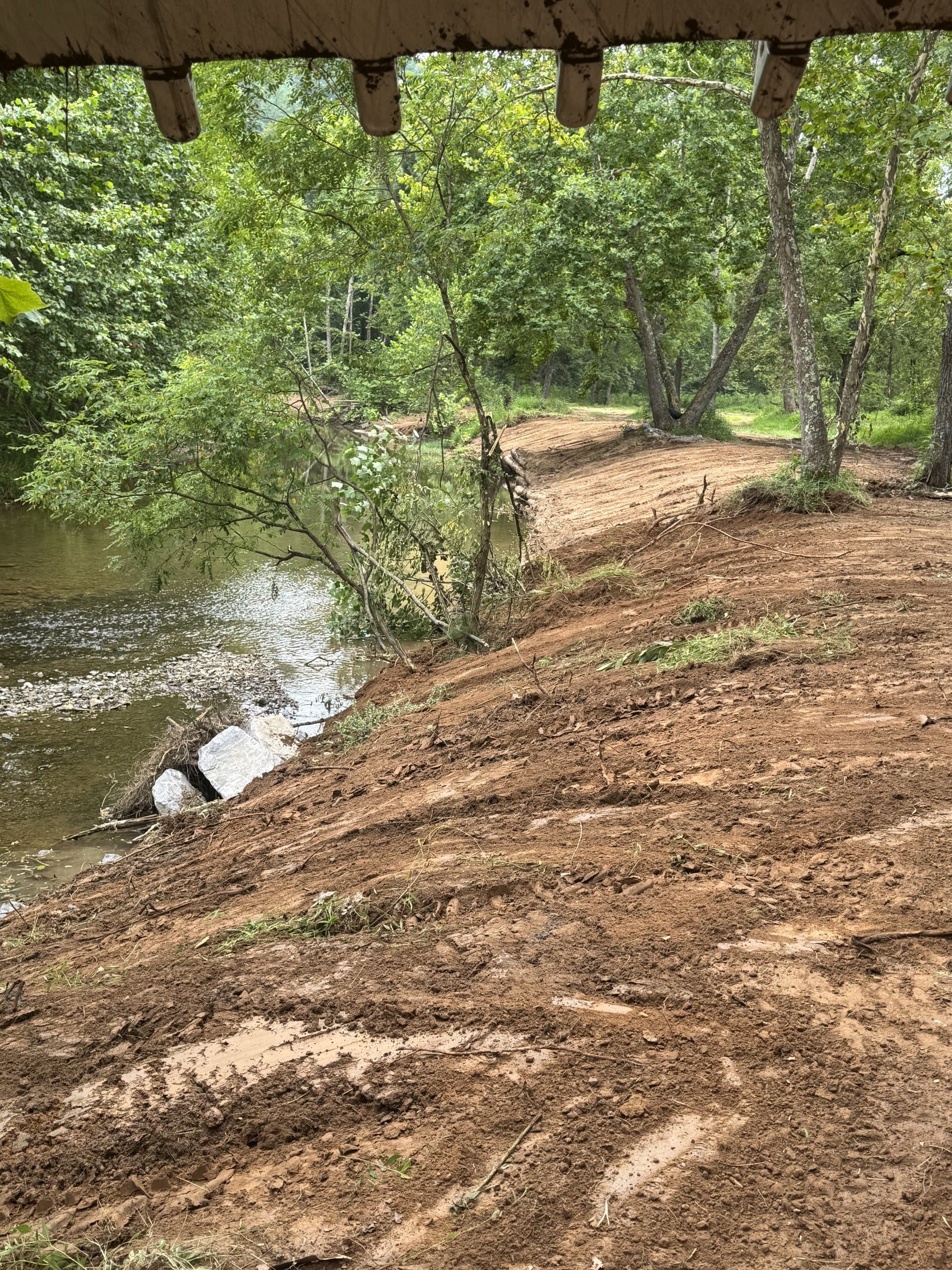 Final residential grade with straw mulch holding the slope