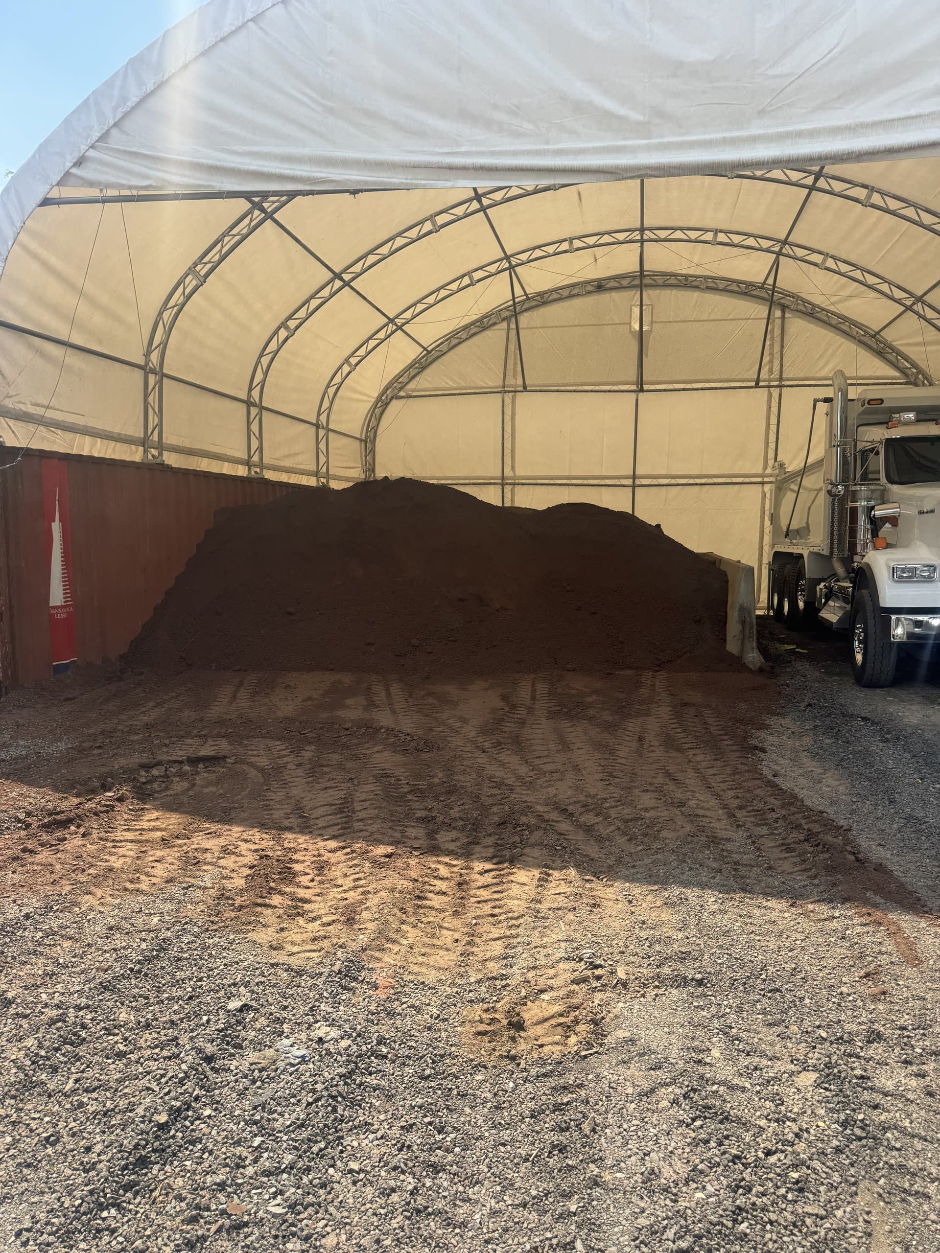 Screened topsoil pile staged under cover at the EW Wise yard