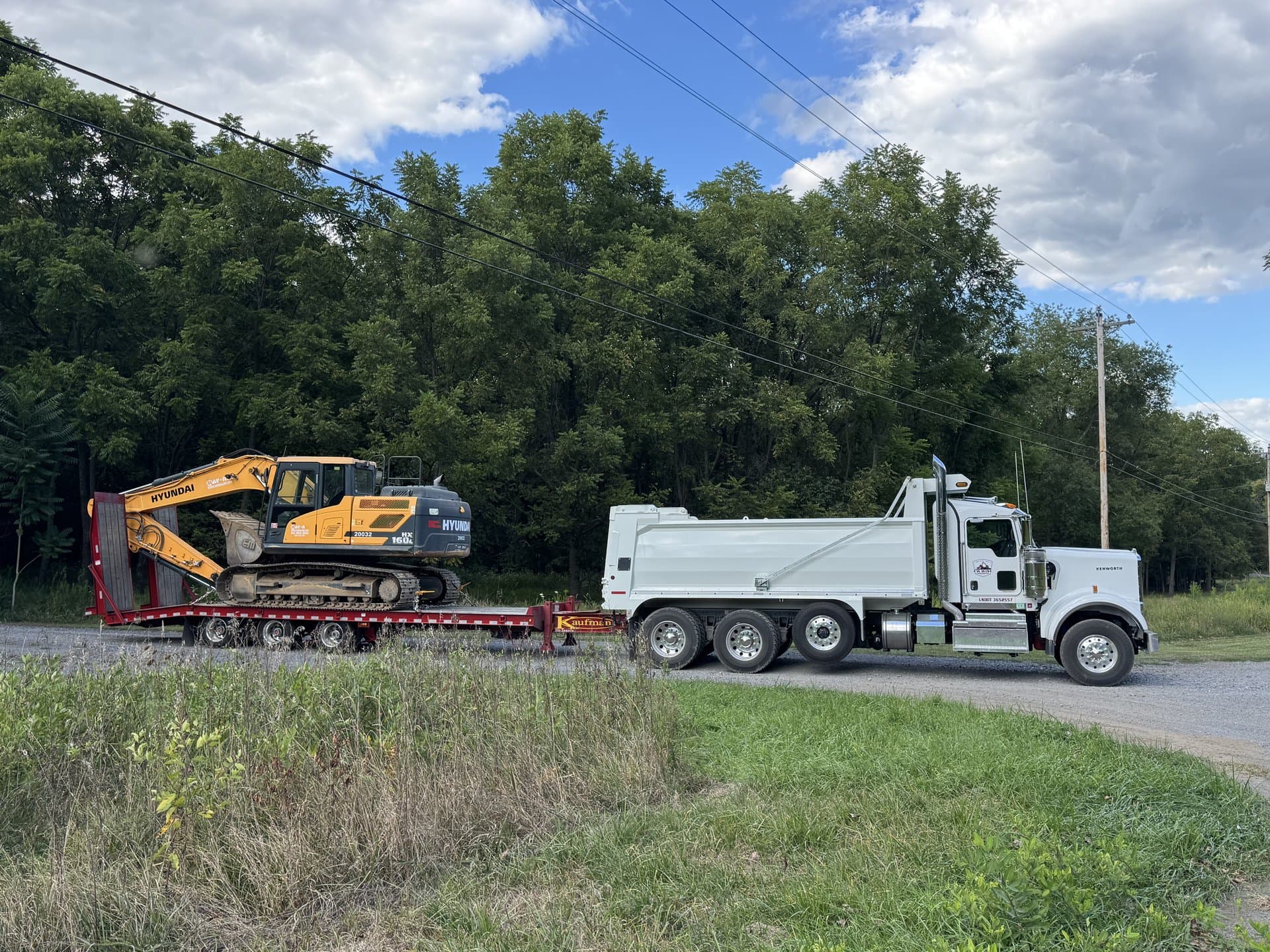 EW Wise Peterbilt dump truck dropping a load of fill on the job site
