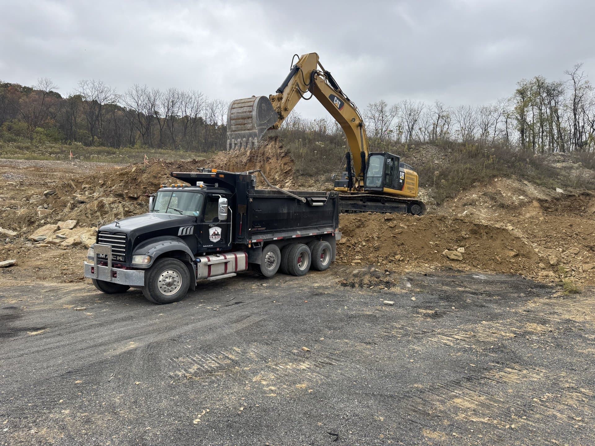 Winter excavation — EW Wise excavator loading the dump truck