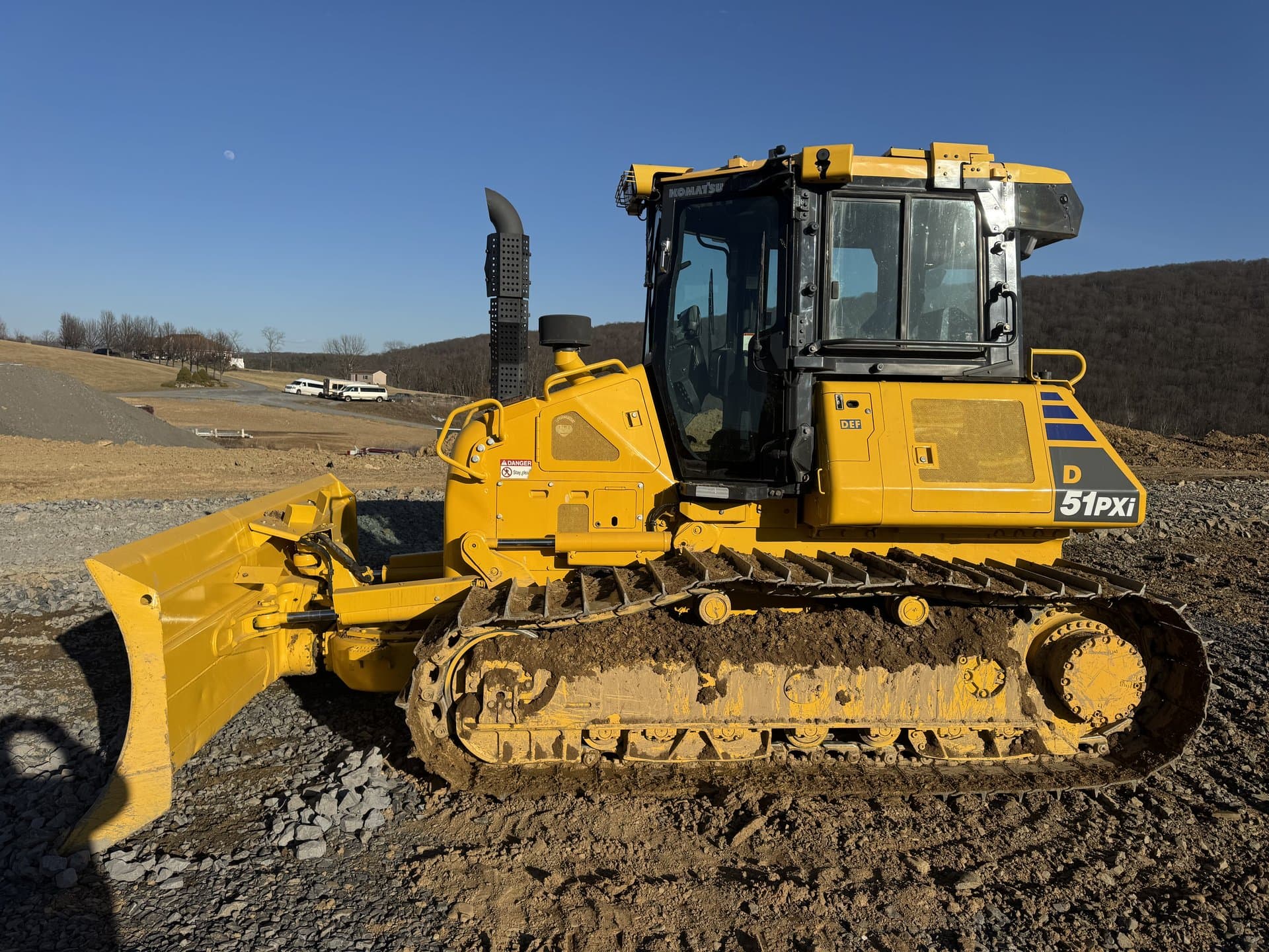 Yellow bulldozer ready for a grading run on a Bedford site