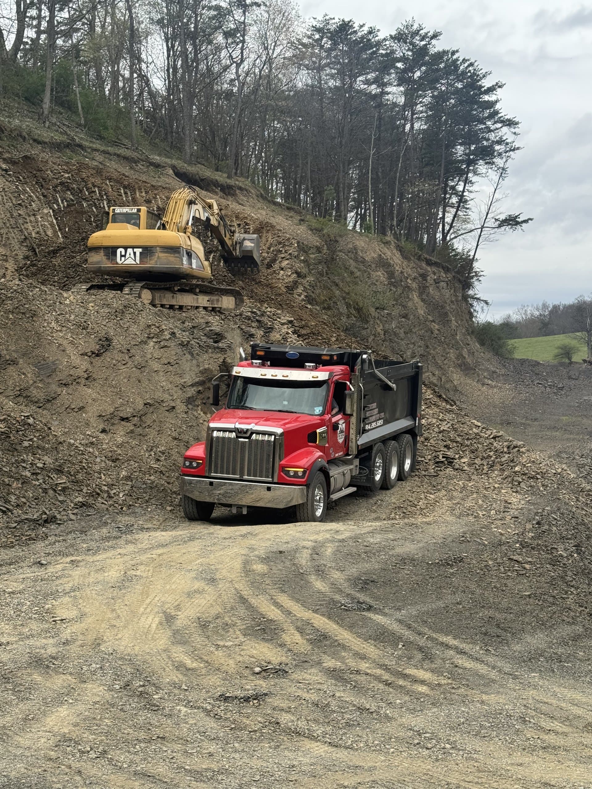 EW Wise truck hauling the excavator on a lowboy trailer