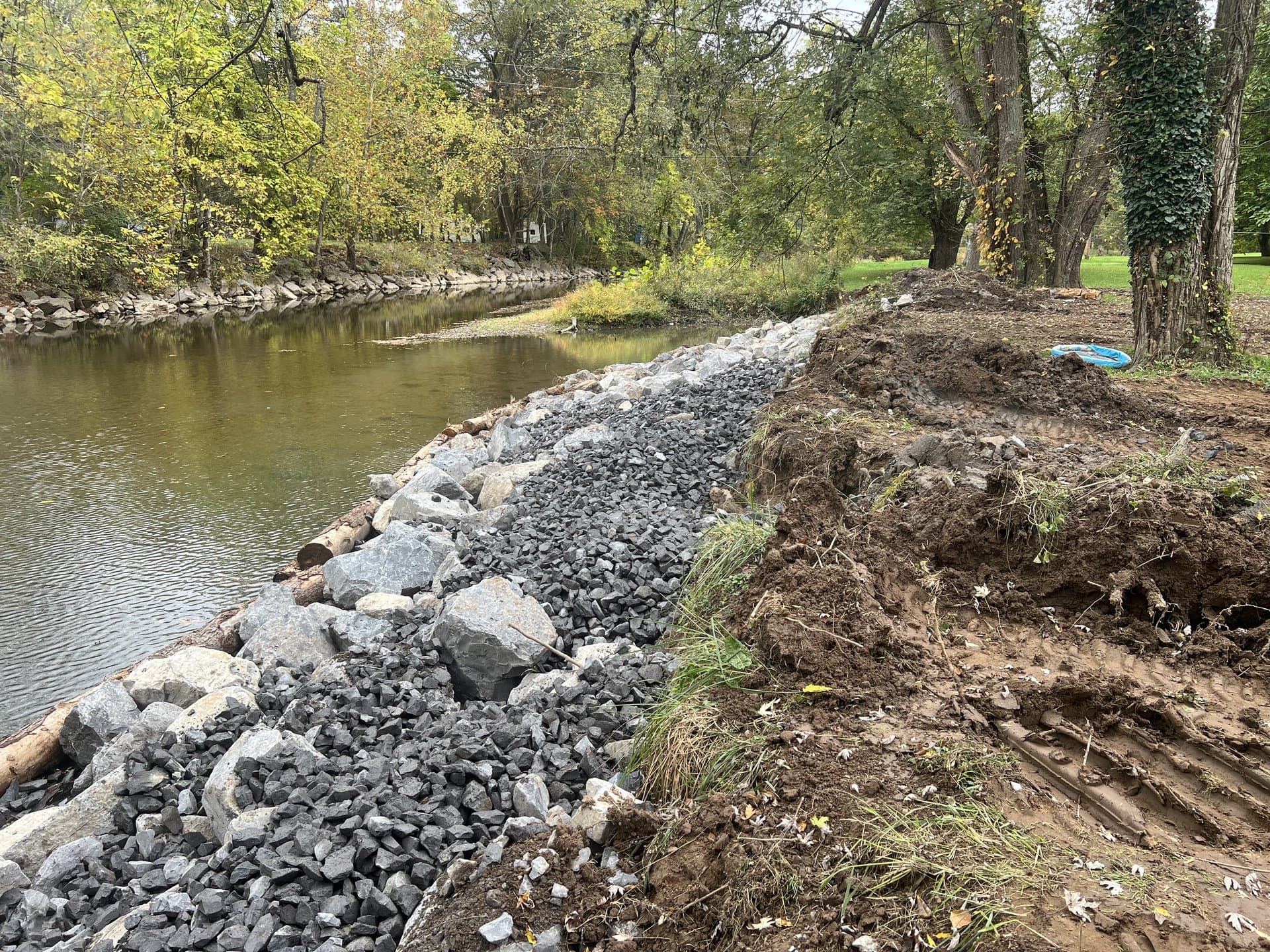 Heavy stone armor protecting a wide stream bank during fall