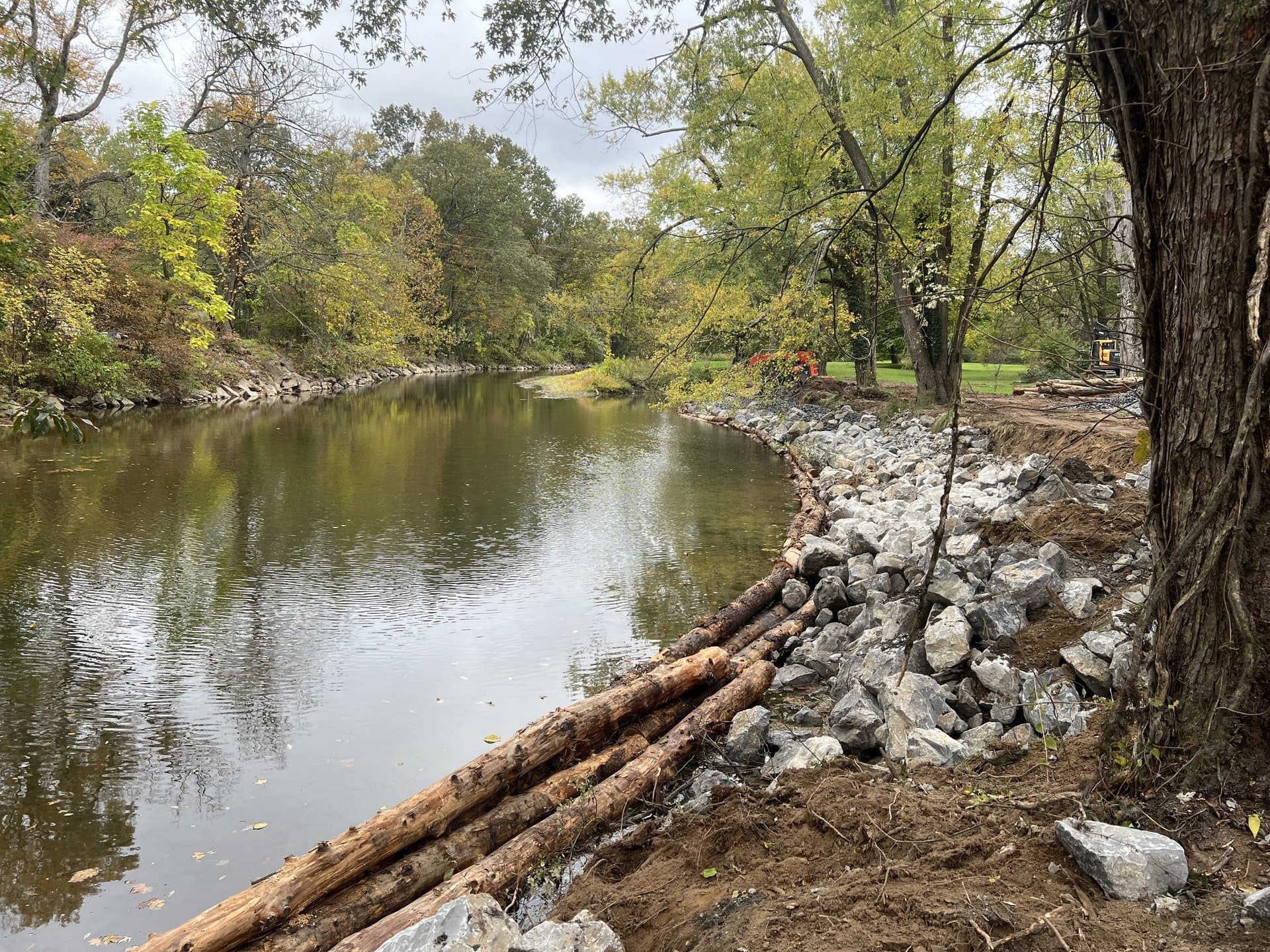 Completed stone armor and log toe on a wide stream restoration project